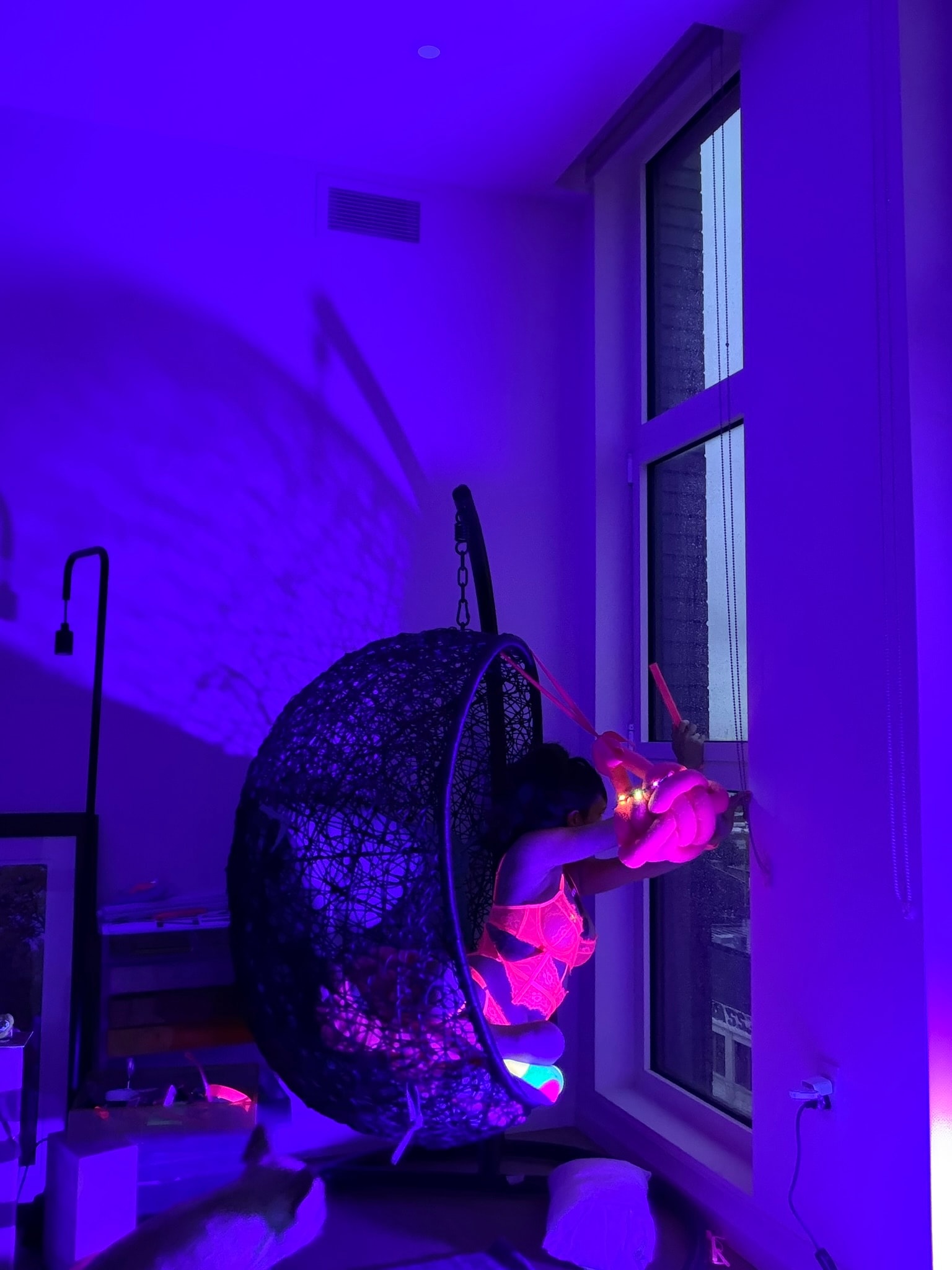 WittyKitty in neon chair purple lighting